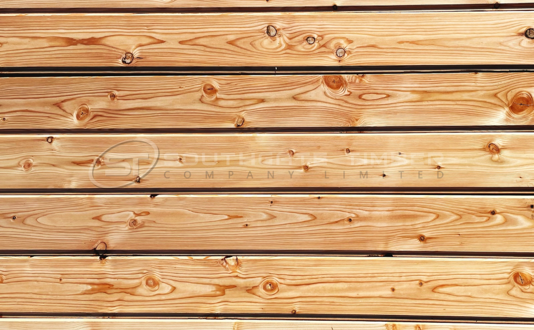 European Larch 20 x 144mm Channel Groove Cladding ST10.L installed horizontally, showing warm golden tones, visible knots, and natural grain pattern, supplied by Southgate Timber.